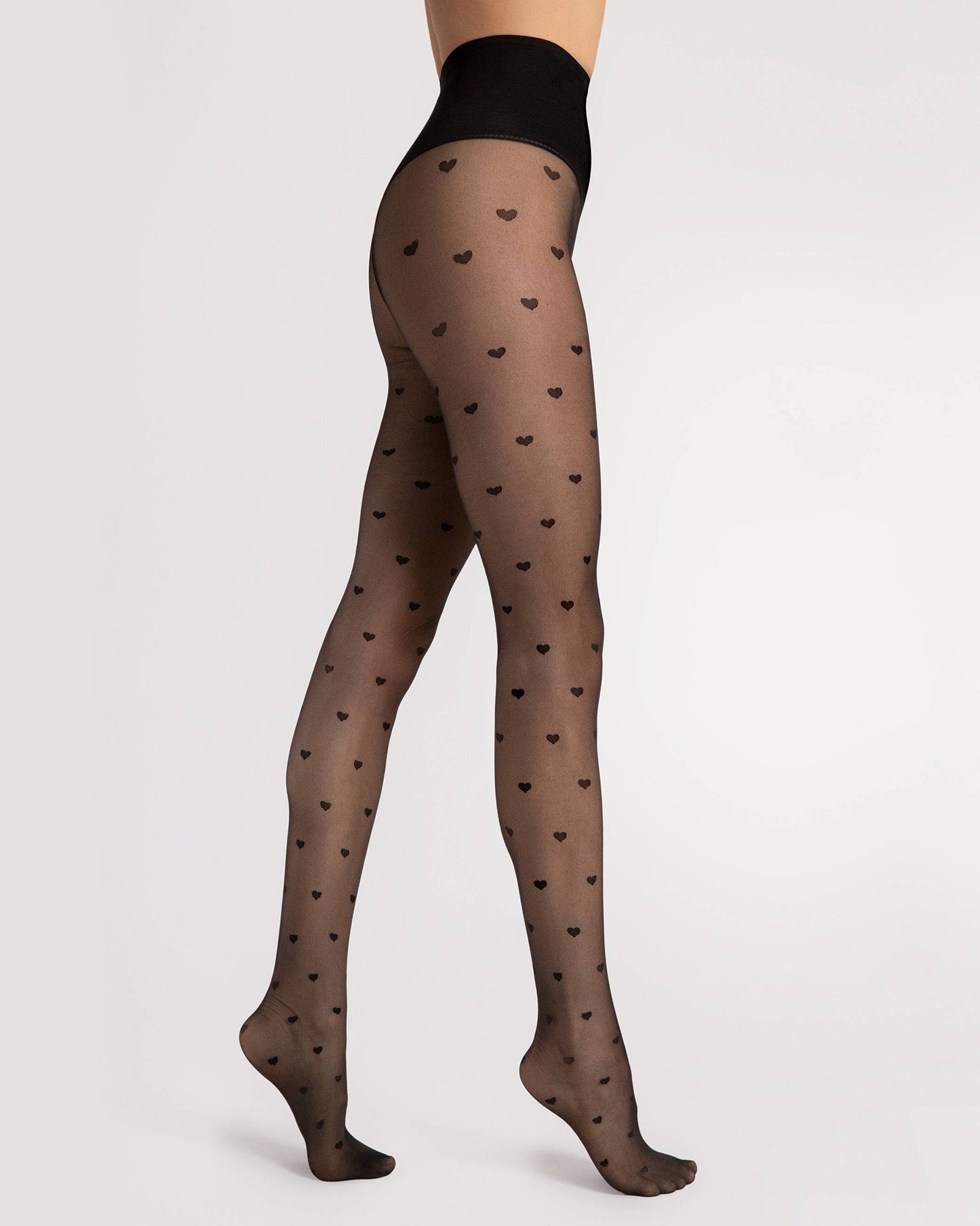 Fiore Heartbeat 20 Den - Sheer black fashion tights with an all over heart pattern and deep high waisted shaping waste band.