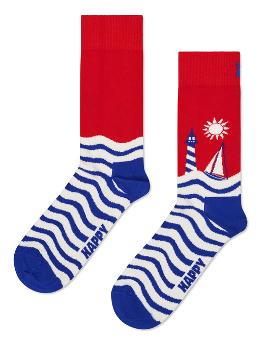 Happy Socks Sail Away Socks - Cotton crew length ankle socks with a stylised sailing scene with a yacht, lighthouse, waves and sun in red, dark blue and off white.