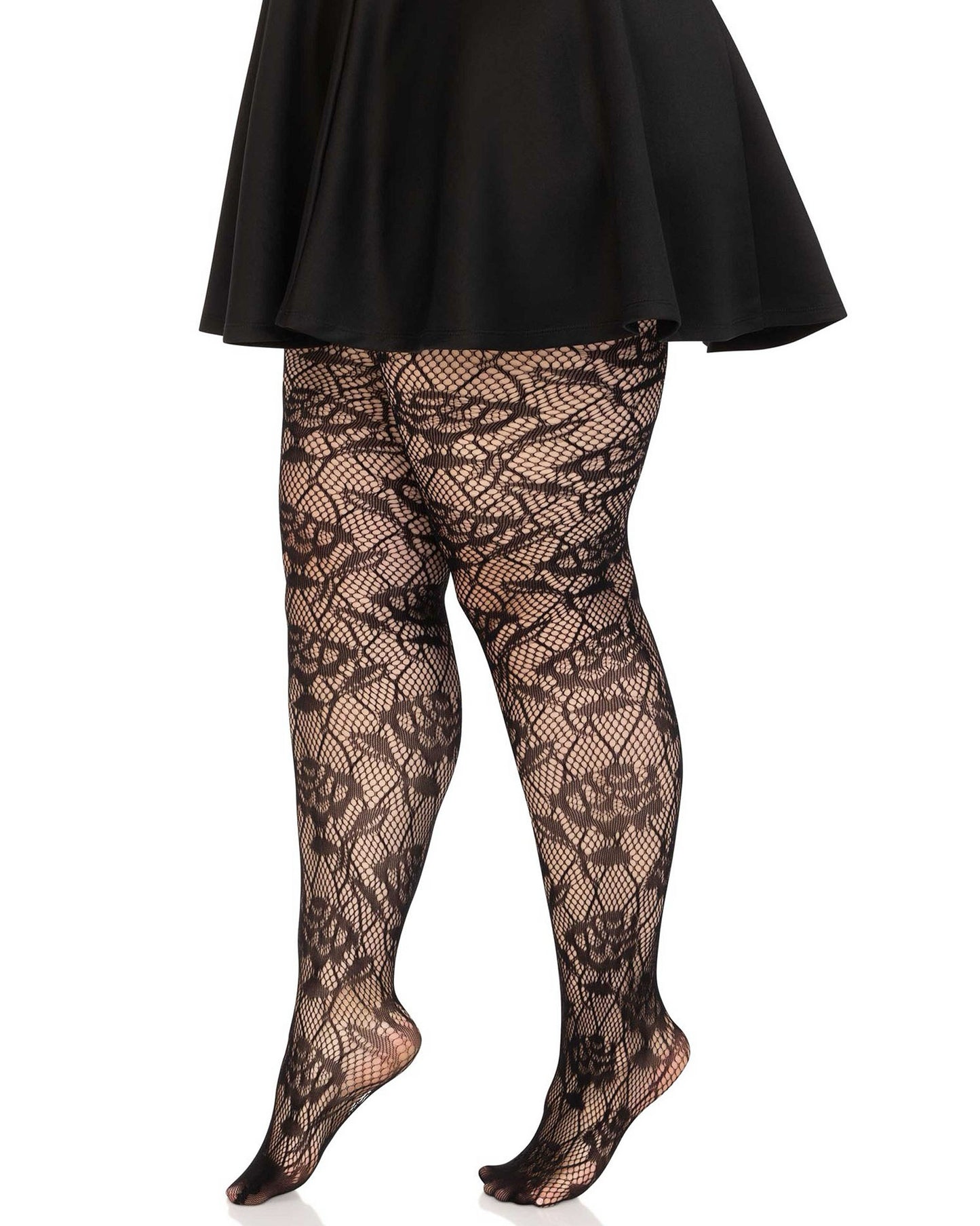 Leg Avenue Wild Rose Net Tights - Curvy plus size black openwork fashion seamless tights with a floral rose fishnet lace style pattern. Worn with frilly black satin skirt and black stilettos. Side view..