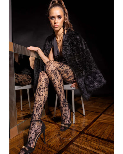 Omero Uranus Collant - Black openwork floral lace fishnet tights with seamless body and reinforced opaque toe. Worn by model wearing black fur coat and high heels.