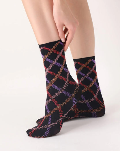 Oroblù Fur Tartan Sock - Black opaque fashion ankle socks with a textured diamond tartan style pattern in purple, pale pink, bright red and gold with a plain thin elasticated cuff. Side view