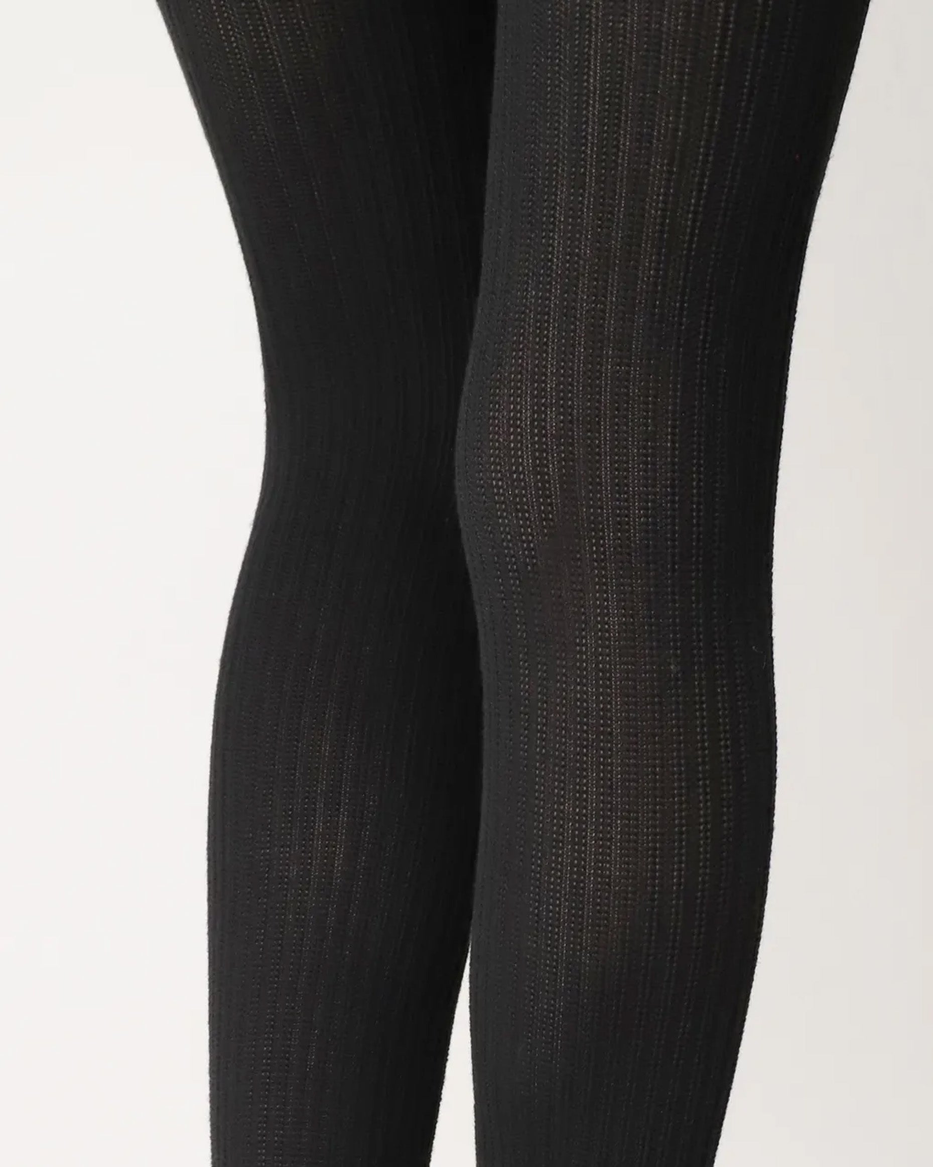 Oroblu Eco Natural Rib Tights - Black ribbed knitted tights made of soft recycled polyester and viscose. Close up of back of knees.