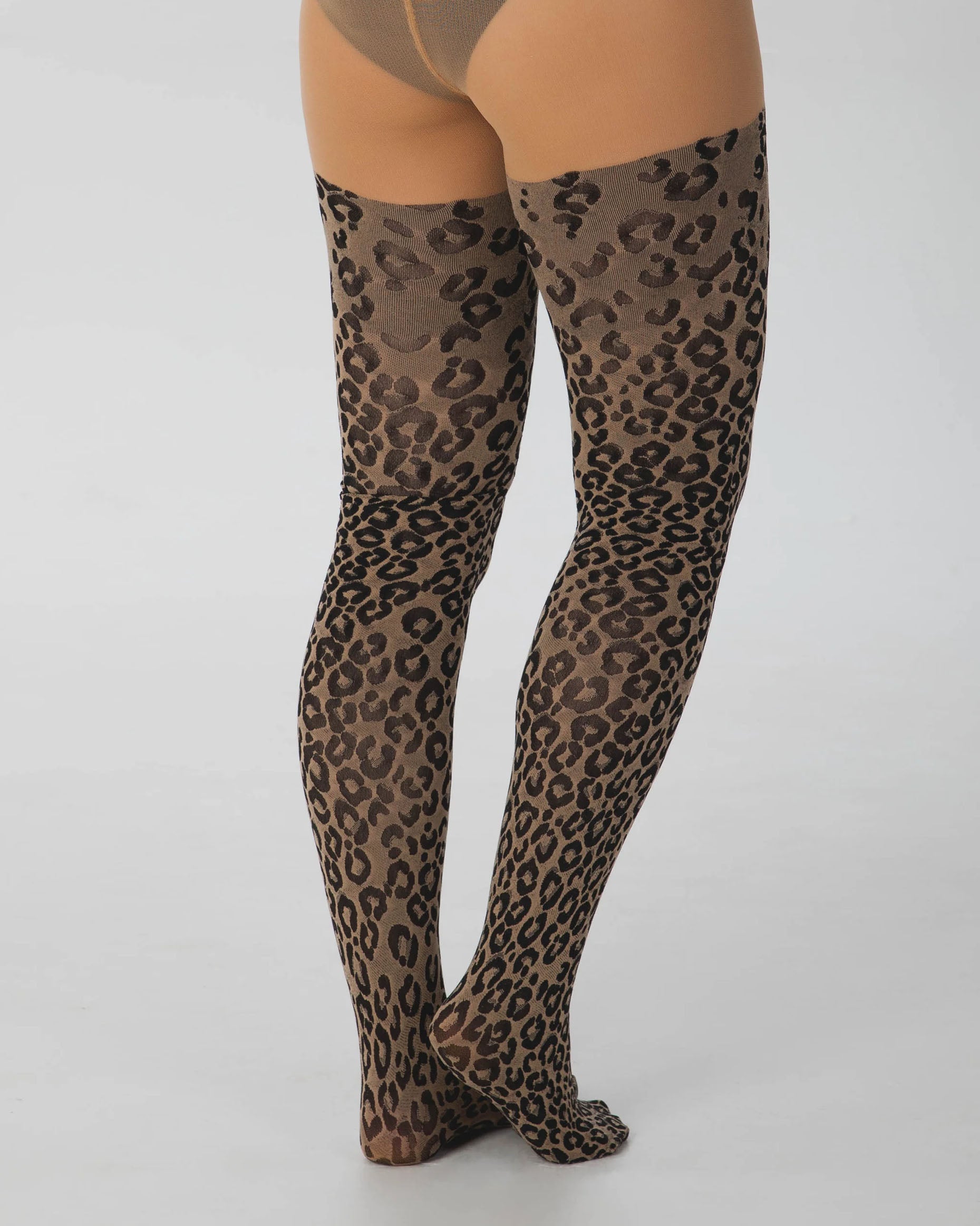 Pamela Mann Woven Leopard Print Tights - Light nude opaque tights with a woven black cheetah print pattern with a plain boxer top. Back view.