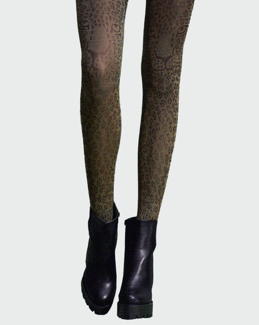 Silvia Grandi The Beast Collant - Beige opaque fashion tights with a woven black leopard print pattern with leopard faces above the knee, worn with black heeled ankle boots.