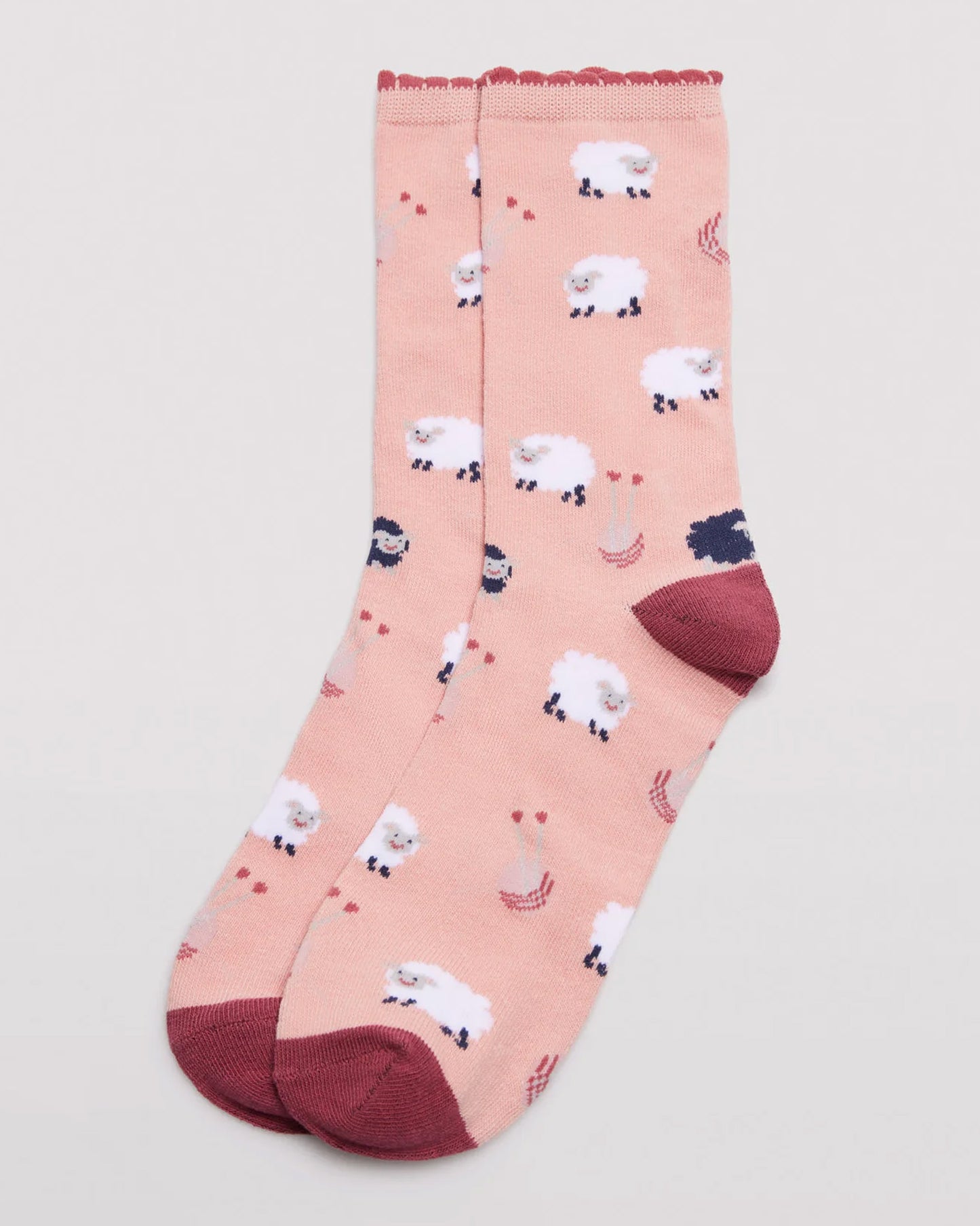 Ysabel Mora 12206 Sheep Socks - Peach crew length cotton ankle socks with an all over pattern of white sheep with the odd navy sheep, terracotta coloured scalloped edge elasticated cuff, terracotta shaped heel and flat toe seam.