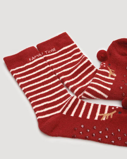 Ysabel Mora 12809 Rudolf Slipper Socks - Dark red fluffy flannel slipper socks gift box with a white stripe pattern, Rudolf at the toe with a red pom pom nose and the text 'Family Time' on the cuff. 