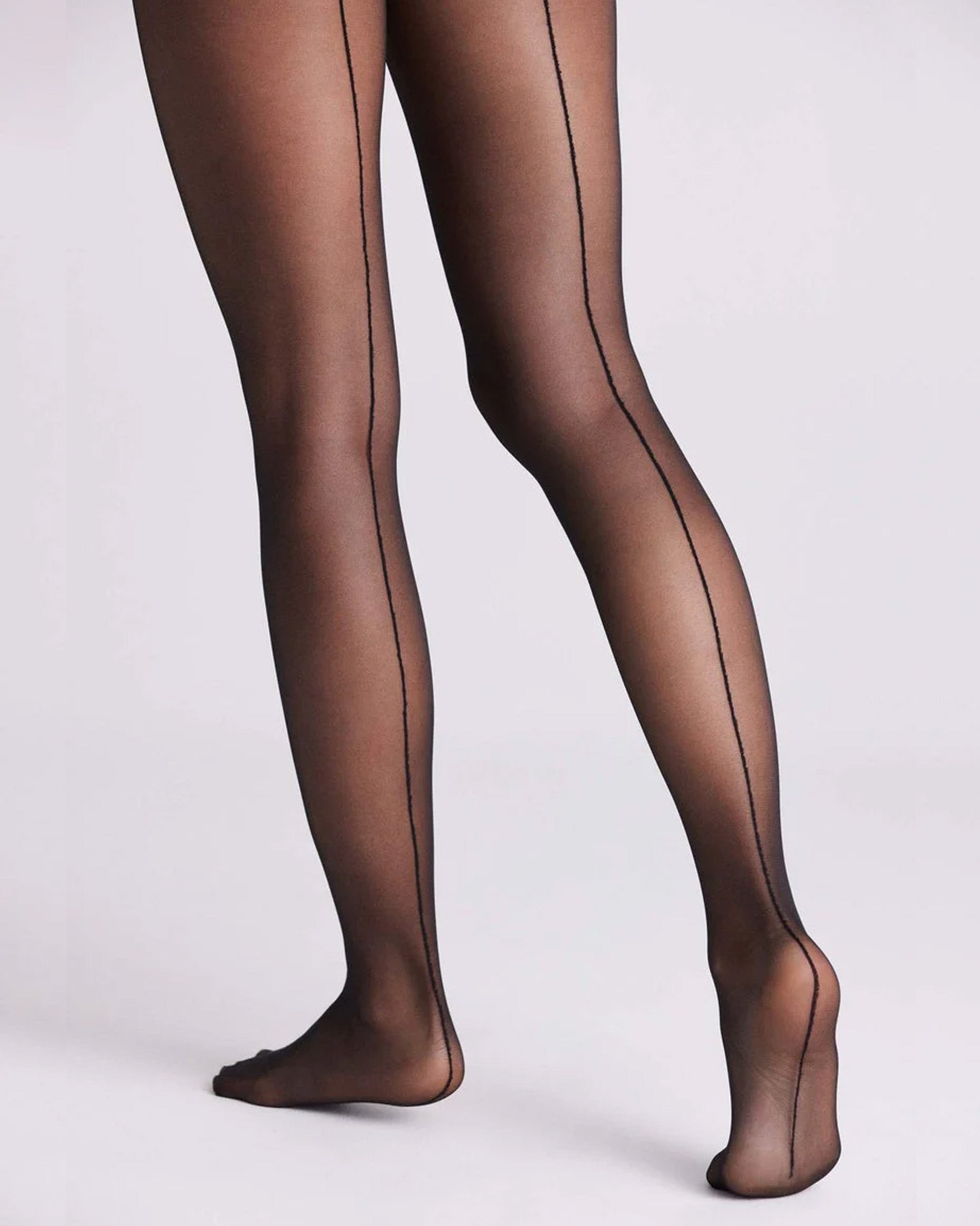 Ysabel Mora 16611 Backseam Tights - Sheer black tights with a back seam line, flat seams, gusset, reinforced toe and comfort waistband. Close up back view.