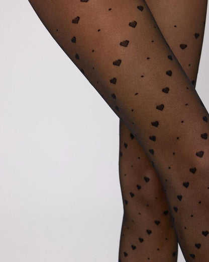 Ysabel Mora 16614 Heart & Spots Tights - Sheer black fashion tights with a diagonal pattern of hearts and spots, close up detail.