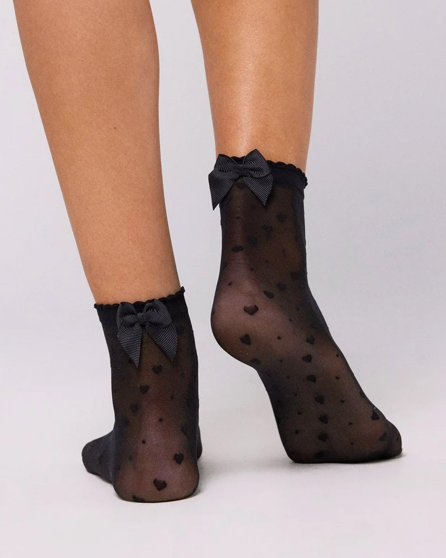 Ysabel Mora 16616 Heart & Bow Socks - Sheer black fashion ankle socks with a diagonal pattern of hearts and spots, scalloped cuff with a satin bow on the back.