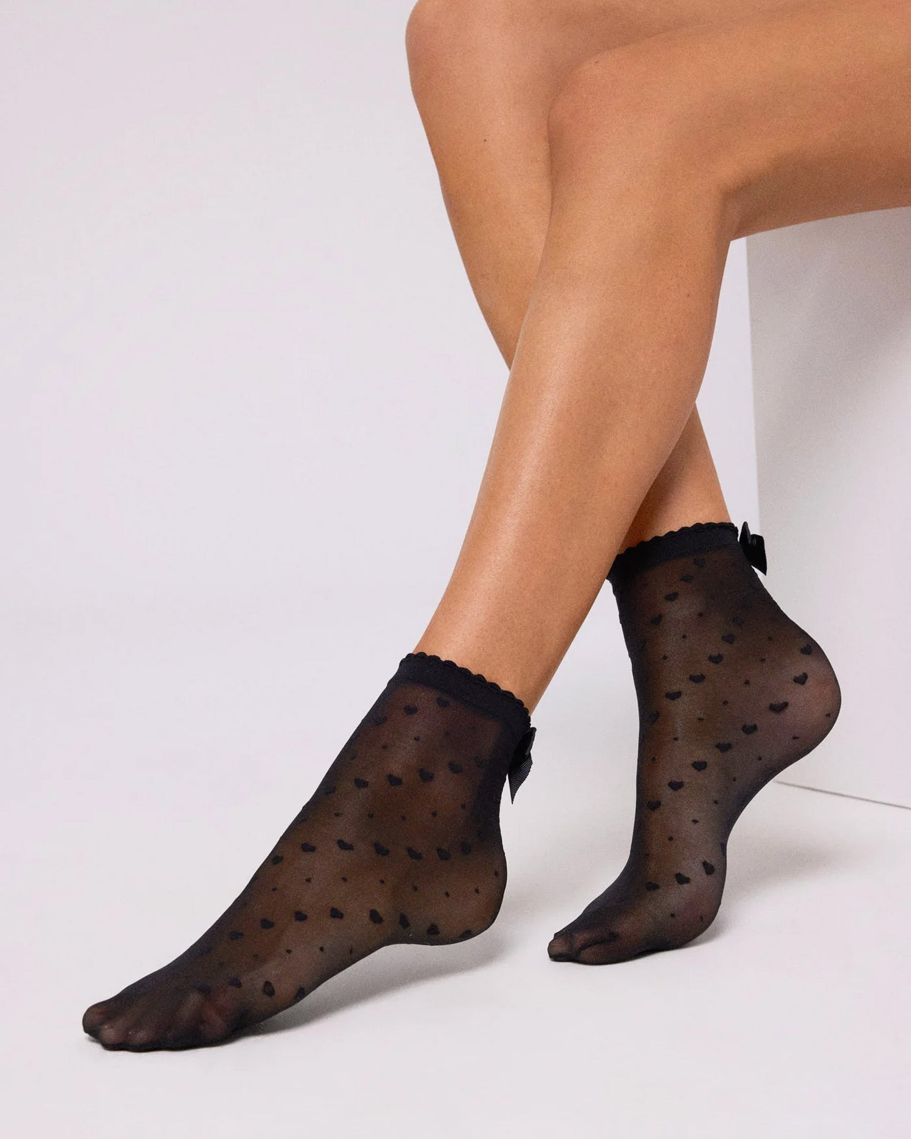 Ysabel Mora 16616 Heart & Bow Socks - Sheer black fashion ankle socks with a diagonal pattern of hearts and spots, scalloped cuff with a satin bow on the back.