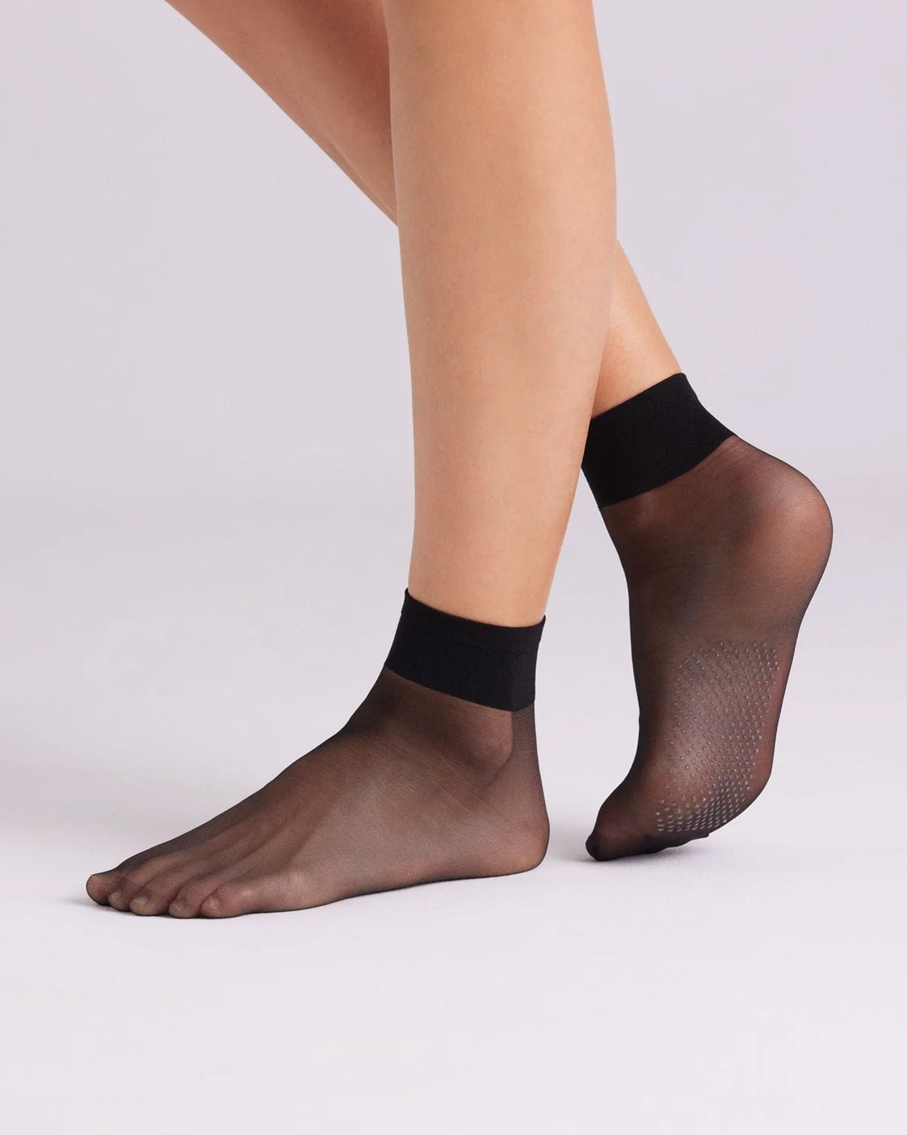 Ysabel Mora 18125 Grip Sole Socks - Sheer black classic ankle socks with a dotted silicone grip sole and deep elasticated comfort cuff. Side view.