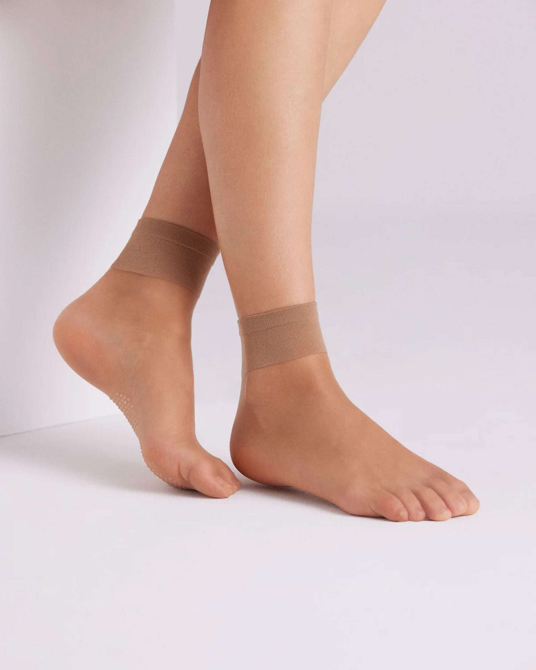 Ysabel Mora 18125 Grip Sole Socks - Sheer natural tan classic ankle socks with a dotted silicone grip sole and deep elasticated comfort cuff. Side view.