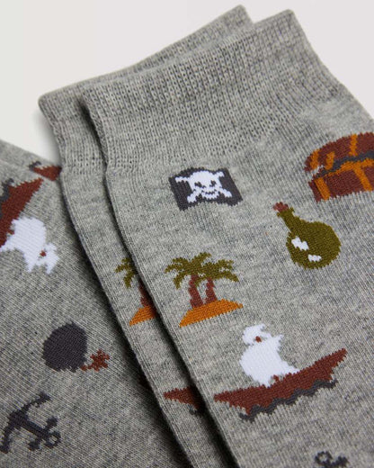 Ysabel Mora 22876 Pirate Socks - Light grey cotton mix crew length ankle socks with an all over pirate themed pattern of tall ships, anchors, bottles, treasure chests, palm tree islands and skull & cross-bones flags.