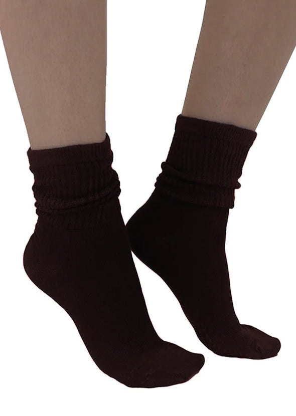 Soft and breathable black bamboo slouch socks with a loose knitted rib top, ankle and foot support and flat toe seams. Side view.