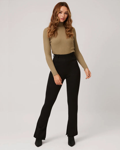 Ysabel Mora 70292 Flare Treggings - Black high waisted boot cut trouser leggings (treggings) with belt loops and inside slits at the bottom, worn with beige polo neck.