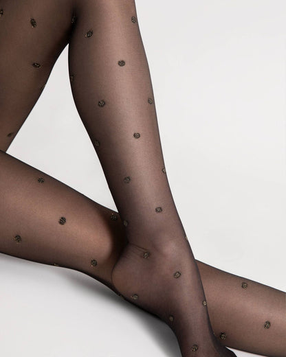 Fiore Confetti Tights - Sheer black fashion tights with a woven sparkly gold polka dot pattern. Close up detail.