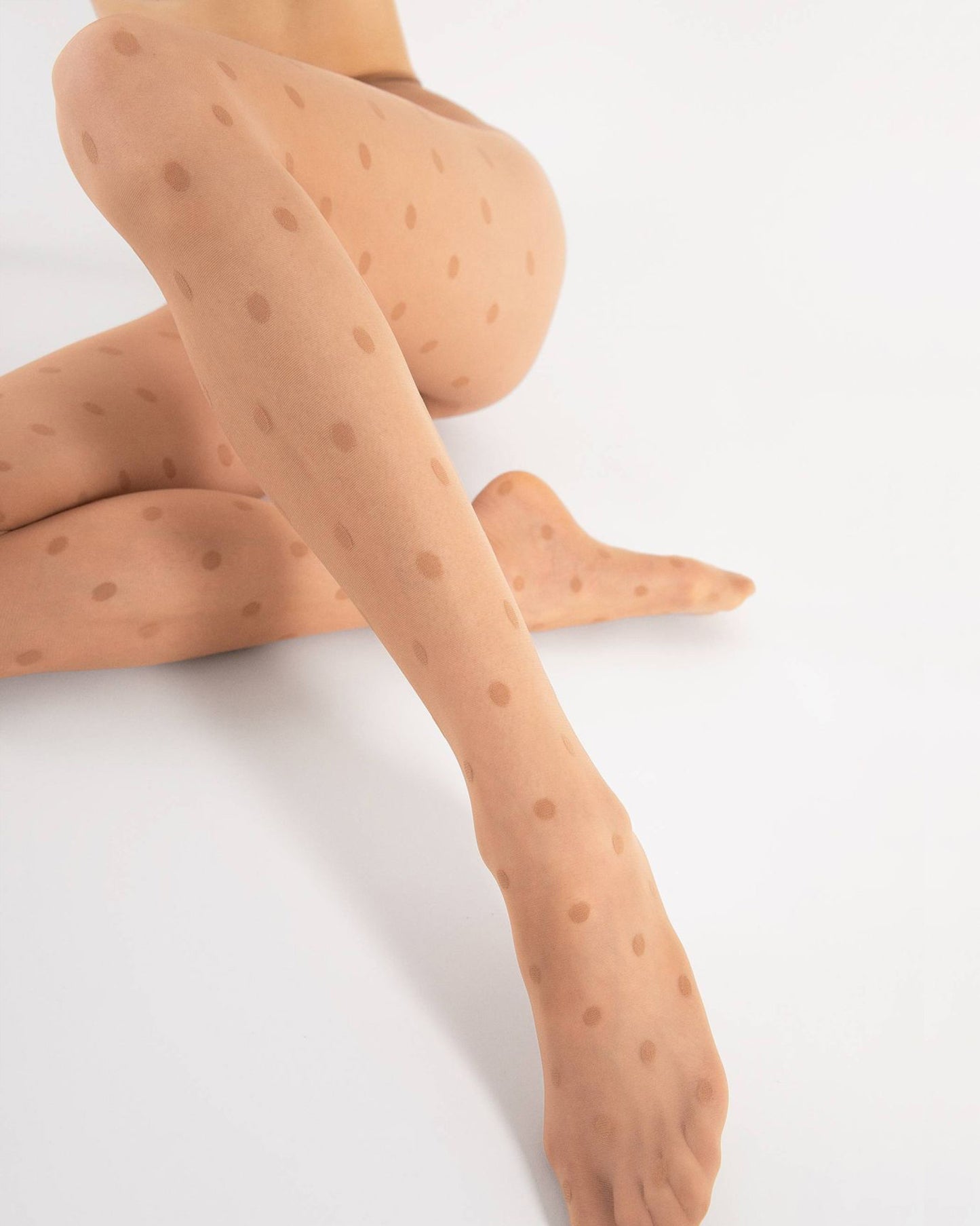 Sheer nude fashion tights with an all over woven polka dot pattern, flat seams, hygienic gusset, invisible reinforced toe.