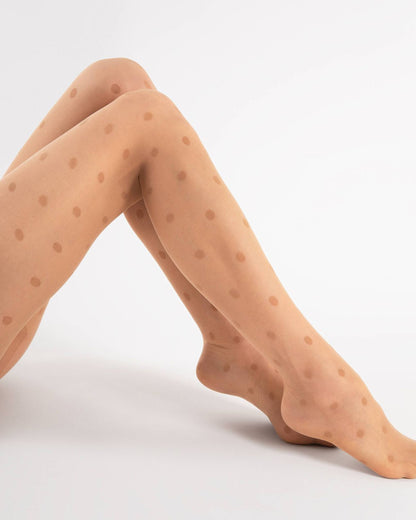 Sheer nude fashion tights with an all over woven polka dot pattern, flat seams, hygienic gusset, invisible reinforced toe. Side view.