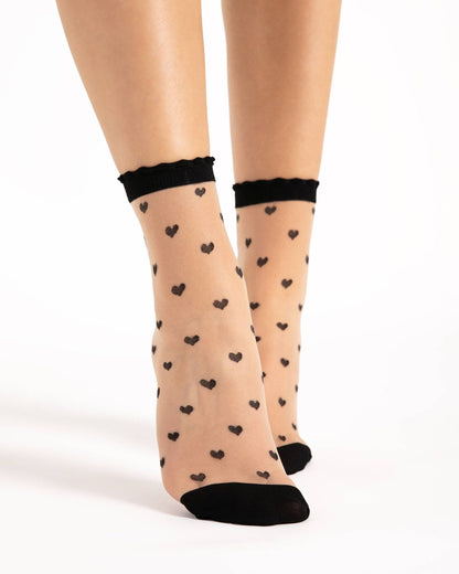 Fiore Iris Sock - Sheer nude fashion ankle socks with an all over black spotted heart pattern and black scalloped edged cuff.