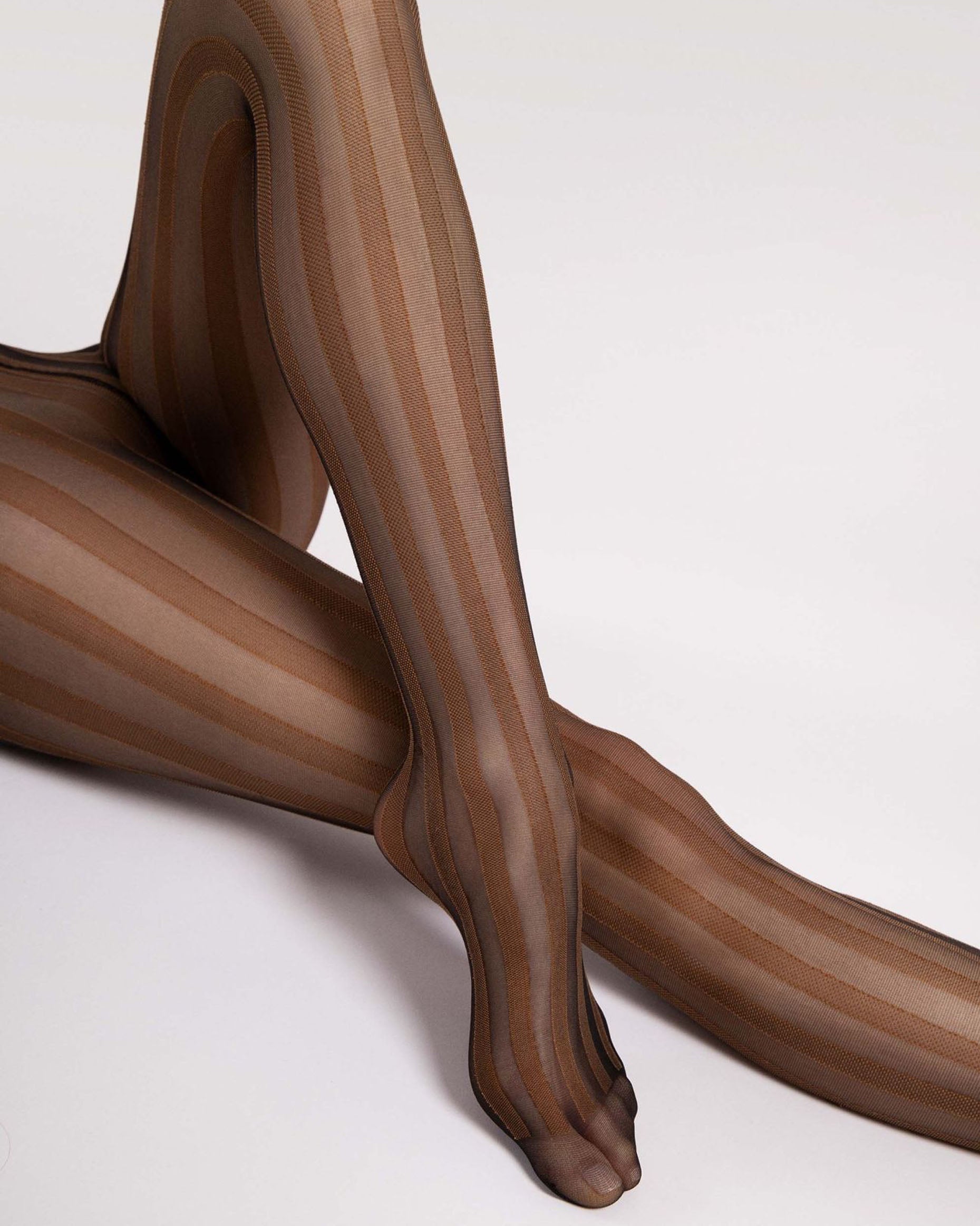 Fiore Raya Tights - Sheer black fashion tights with a woven brown vertical stripe pattern. Close up.