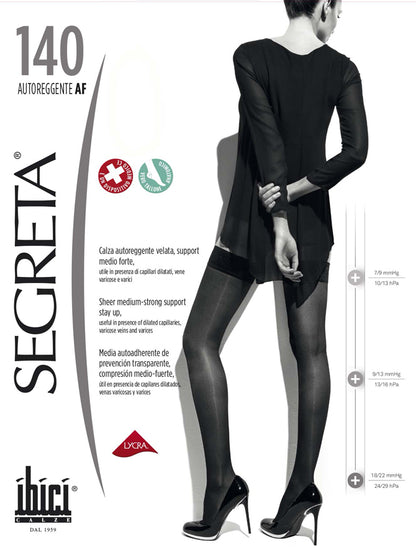 Ibici Segreta 140 Autoreggente - Pack of black medium-strong compression support hold-ups. These hold-ups are transparent with a light mesh look with lace top and silicone, anatomical heel and reinforced toes. Useful in the presence of dilated capillaries, varicose veins and for long haul flights.