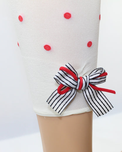 Omsa Papillon Pantacollant - Soft opaque cream kid's footless tights with an all over red polka dot spot pattern and a striped white and black ribbon bow with red twine on the back.