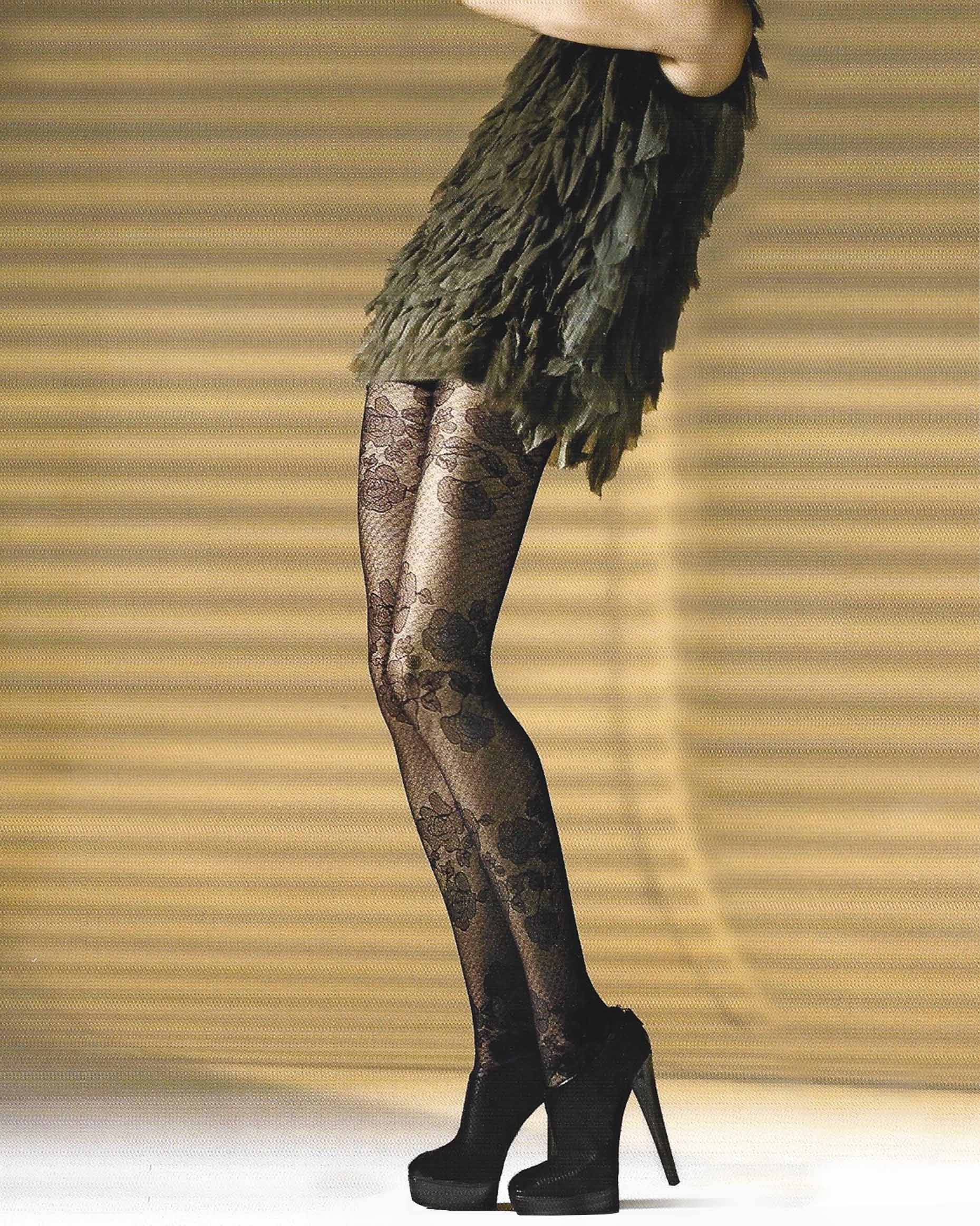 Omsa Shiver Collant - Sheer black fashion tights with a floral and mesh style pattern, worn with black heels and ruffled short dress.