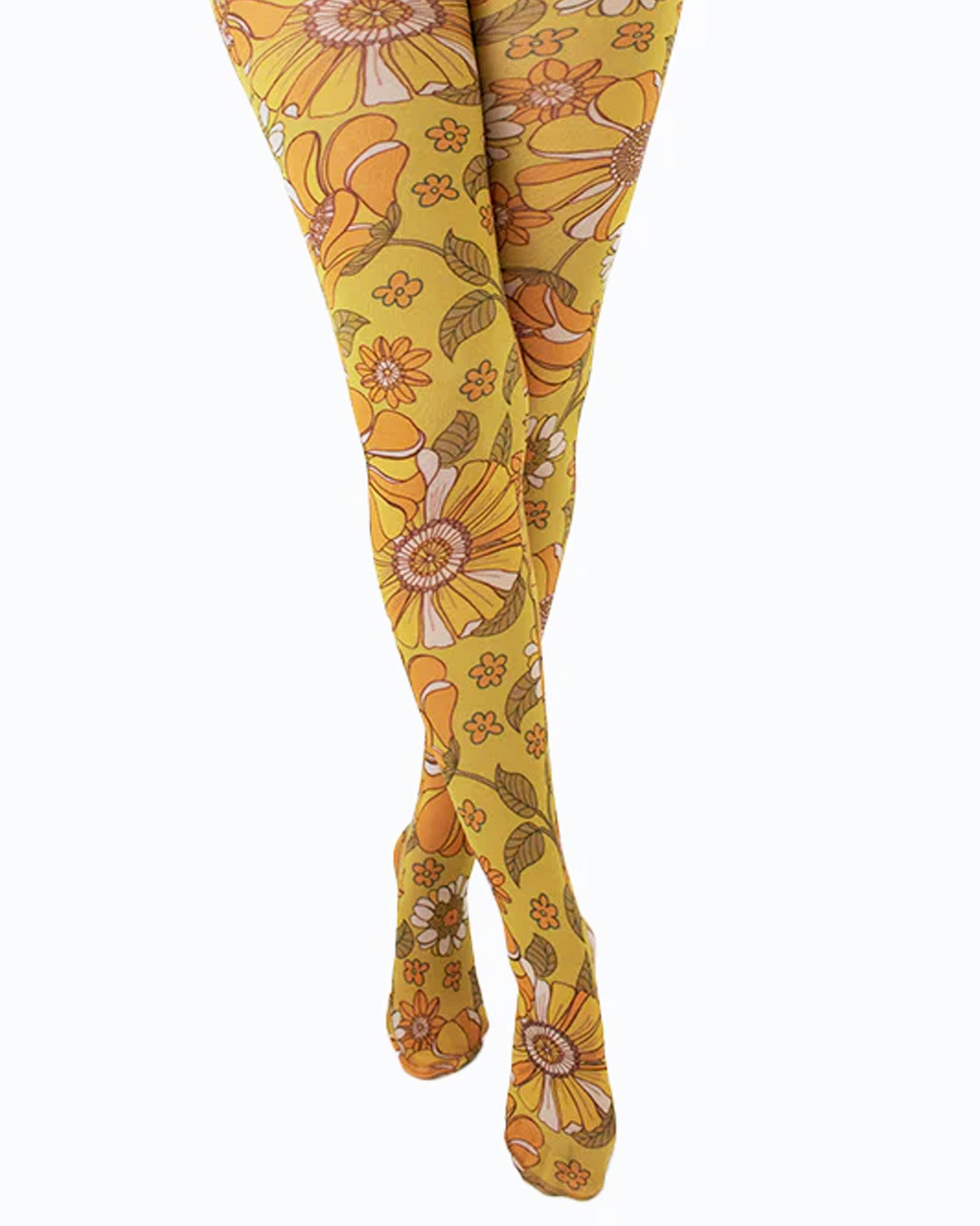 Pamela Mann Throwback Flower Tights - Cream opaque tights with a sixties style flower print pattern in bright shades of mustard and orange, outlined in brown. Close up.