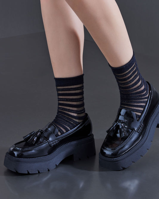 SiSi Fluffy Calzino - Black soft opaque and sheer veiled fur-effect horizontal stripes with raw cut comfort cuff, silver stripe, shaped heel and flat toe seam. Worn with chunky black loafers.