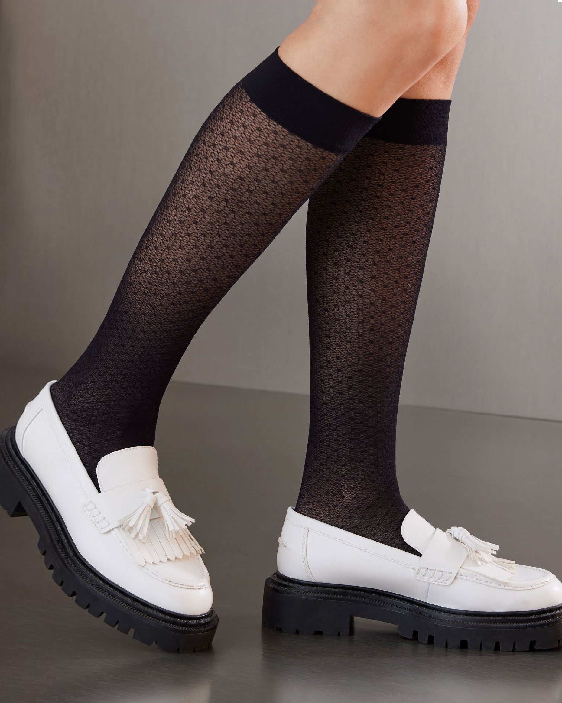 SiSi Point Gambaletto - Sheer black micro-mesh fashion knee-high socks with a circular dotted vertical stripe style pattern and plain deep comfort cuff. Worn with white loafers.